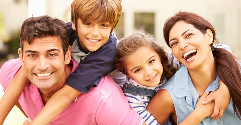 Family laughing on couch