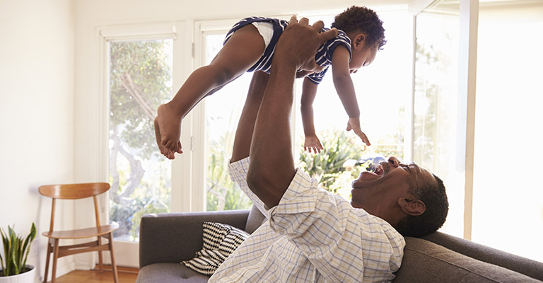 Man playing with baby