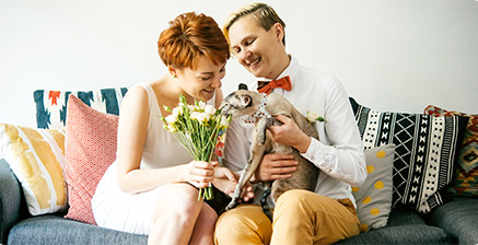 Couple holding cat on a couch