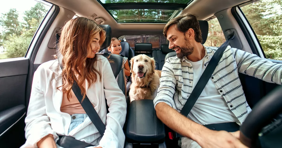 Family in car smiling